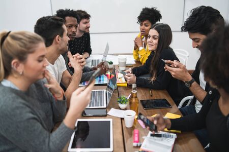 Group of multiethnic creative business people working on a project and having a brainstorming meeting. Discussing development of project. Team work and brainstorming concept.の写真素材