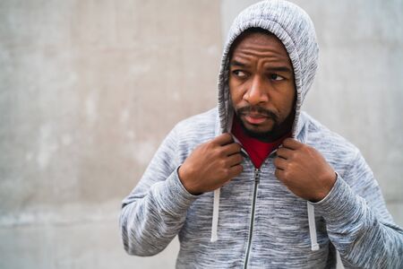 Portrait of an athletic man wearing sport clothes against grey background. Sport and healthy lifestyle.の写真素材