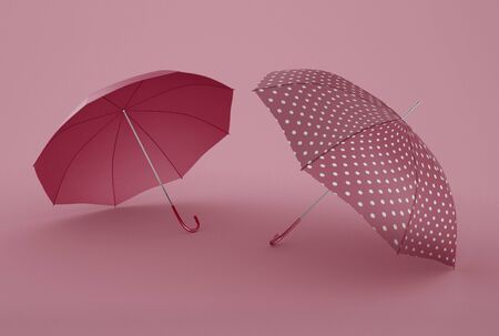 3D Illustration. Set of open pink umbrellas for rain protect against isolated green background. Lying, side view.の写真素材