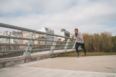 Portrait of an athletic man running outdoors in the street. Sport, fitness and healthy lifestyle.の写真素材