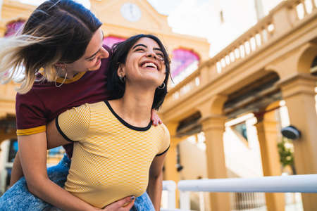 Portrait of lovely lesbian couple spending time together and having fun at the street. LGBT concept.の写真素材