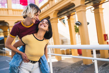 Portrait of lovely lesbian couple spending time together and having fun at the street. LGBT concept.の写真素材