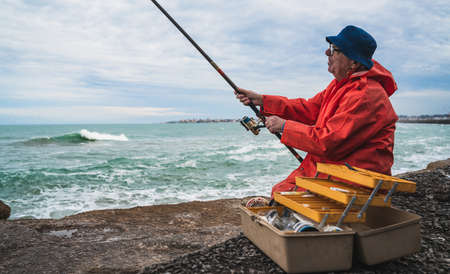 Old man fishing in the sea.の写真素材