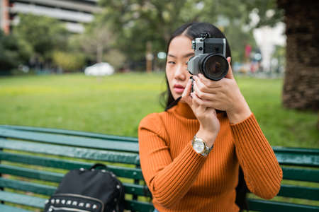 Asian woman using a professional camera.の写真素材