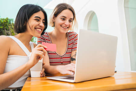 Two young friends doing shop online.の写真素材