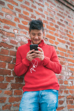Man using his mobile phone with earphones.