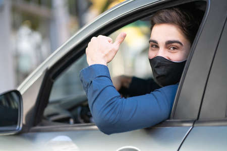 Young man driving his car.の写真素材
