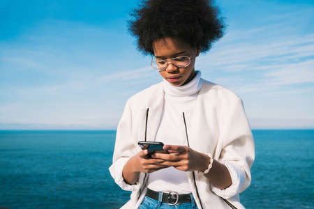 Young woman using her mobile phone.