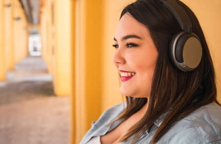 Woman listening to music with headphonesの写真素材