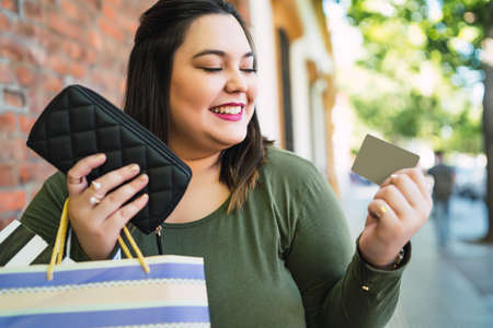 Young woman doing shopping with credit card.
