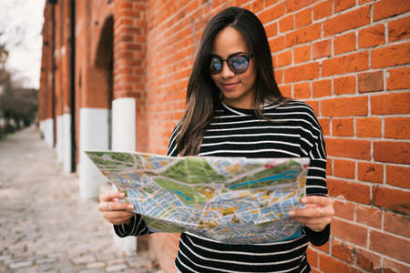 Young traveler woman with a map.