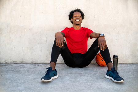 Athletic man relaxing after work out outdoors.の写真素材