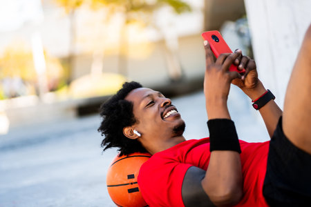 Athlete man using his mobile phone.の写真素材