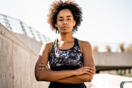 Afro athlete woman standing outdoors.