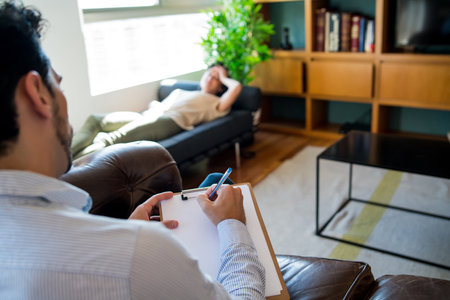 Psychologist talking with patient on therapy session.の写真素材
