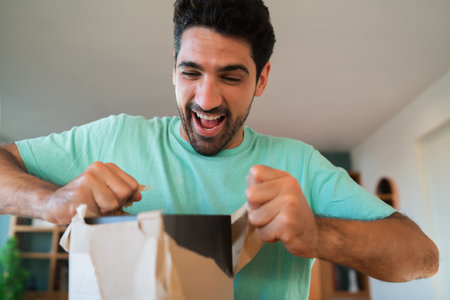 Surprised man opening a gift box.の写真素材