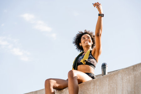 Athlete woman taking a selfie with phone outdoors.の写真素材