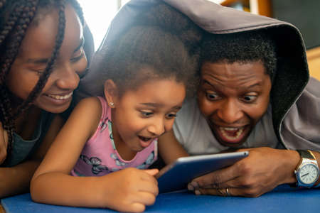 Family using digital tablet at home.の写真素材