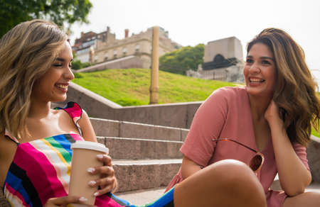 Two friends spending time together outdoors.の写真素材