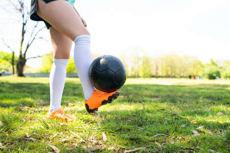 Young woman practicing soccer skills with ball.の写真素材