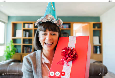 Woman celebrating her birthday online at home.