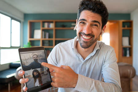 Man on a video call with friends.の写真素材