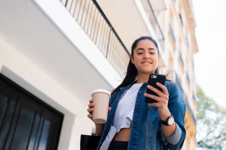 Young woman using her mobile phone.