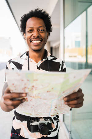 Tourist man looking for directions on map.