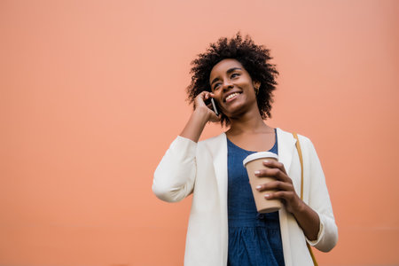 Business woman talking on the phone outdoors.の写真素材