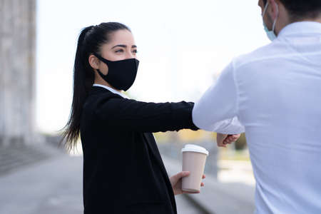 Business people bumping elbows for greeting each other.の写真素材