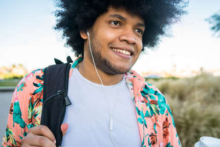 Latin man walking outdoors.