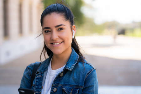 Woman listening to music with earpods.の写真素材