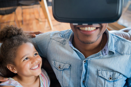 Father and daughter playing video games.の写真素材
