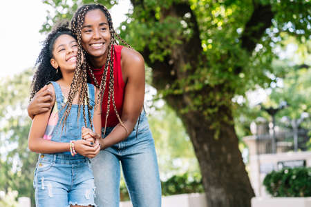 Mother and daughter enjoying a walk together outdoors.