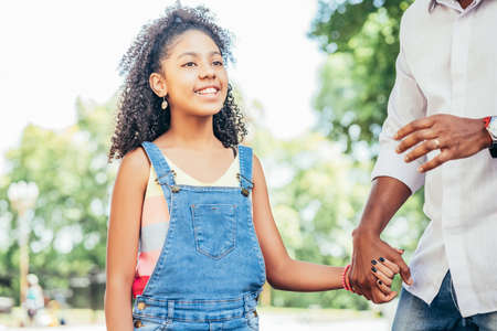 Father and daughter enjoying a walk together outdoors.の写真素材