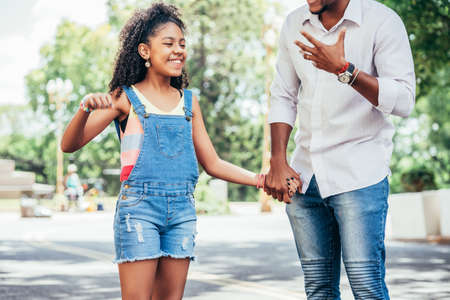 Father and daughter enjoying a walk together outdoors.の写真素材