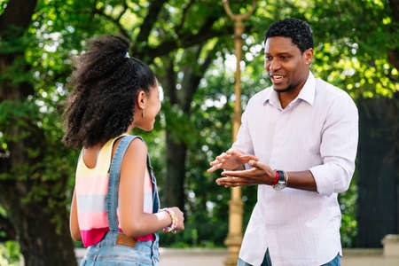 Father and daughter having good time together outdoors.