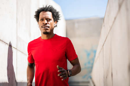 Athletic man running and doing exercise outdoors.の写真素材