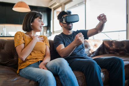 Couple playing video games with VR glasses.の写真素材