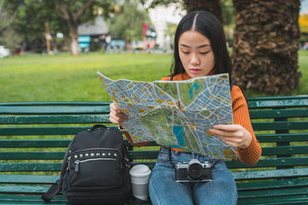 Asian woman looking at a map.
