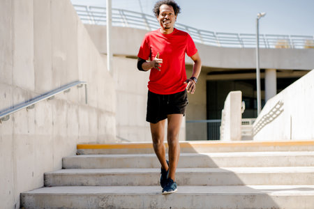 Afro athletic man doing exercise outdoors.の写真素材