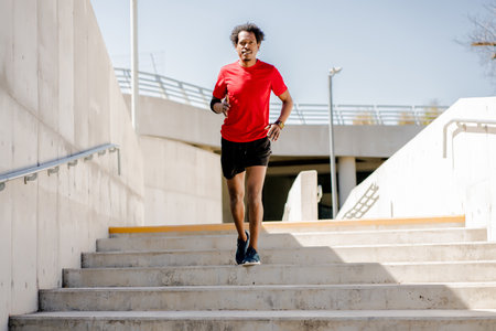 Afro athletic man doing exercise outdoors.
