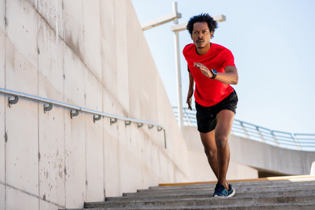 Athletic man running and doing exercise outdoors.の写真素材