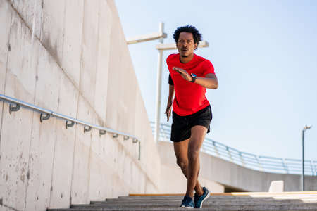 Athletic man running and doing exercise outdoors.の写真素材