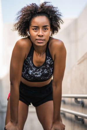 Athlete woman relaxing after work out outdoors.の写真素材