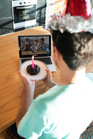 Man celebrating birthday online from home.の写真素材