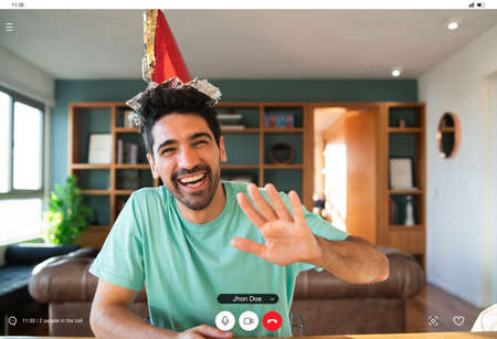 Man celebrating his birthday on a video call.の写真素材