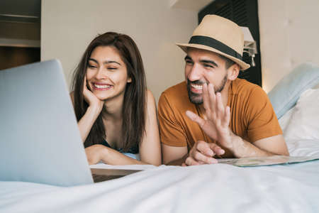 Couple organizing their trip at hotel room.の写真素材