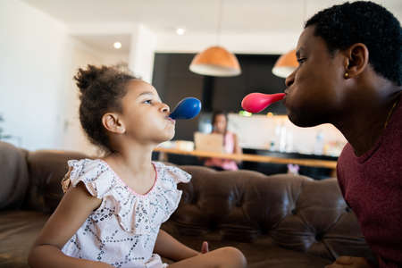 Daughter and father playing together at home.の写真素材
