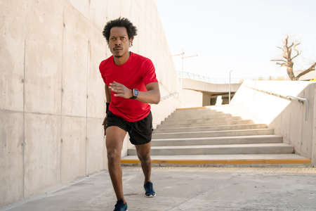 Athletic man running and doing exercise outdoors.の写真素材